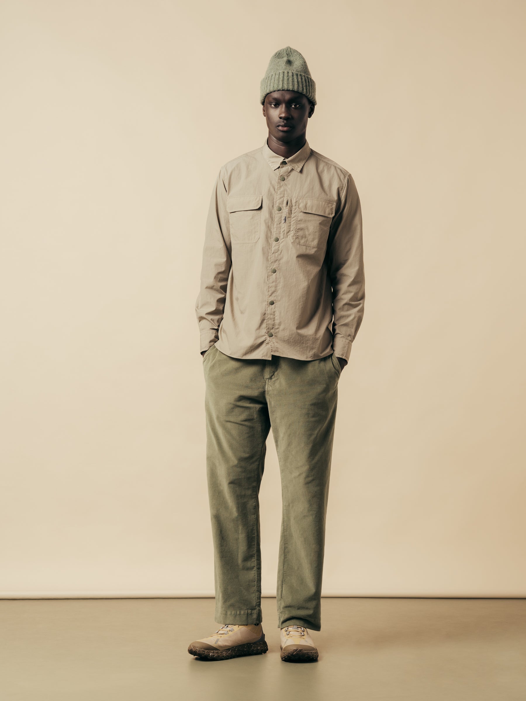 A model wearing a green and grey outfit from Scottish menswear designer KESTIN.