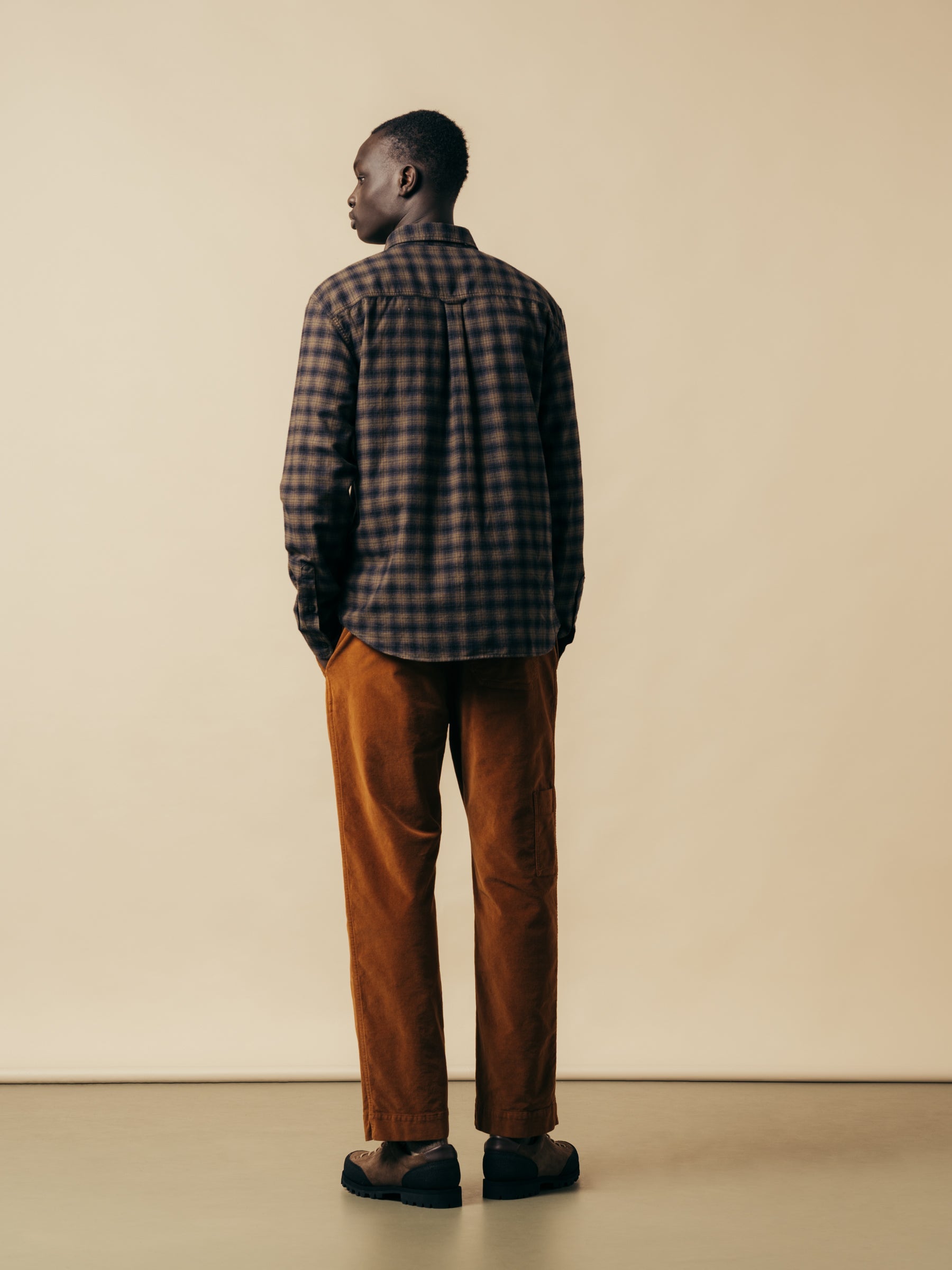 A model wearing brown moleskin trousers from designer menswear brand KESTIN.