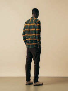 A model showing the back of the Dirleton Flannel Shirt in green and yellow.