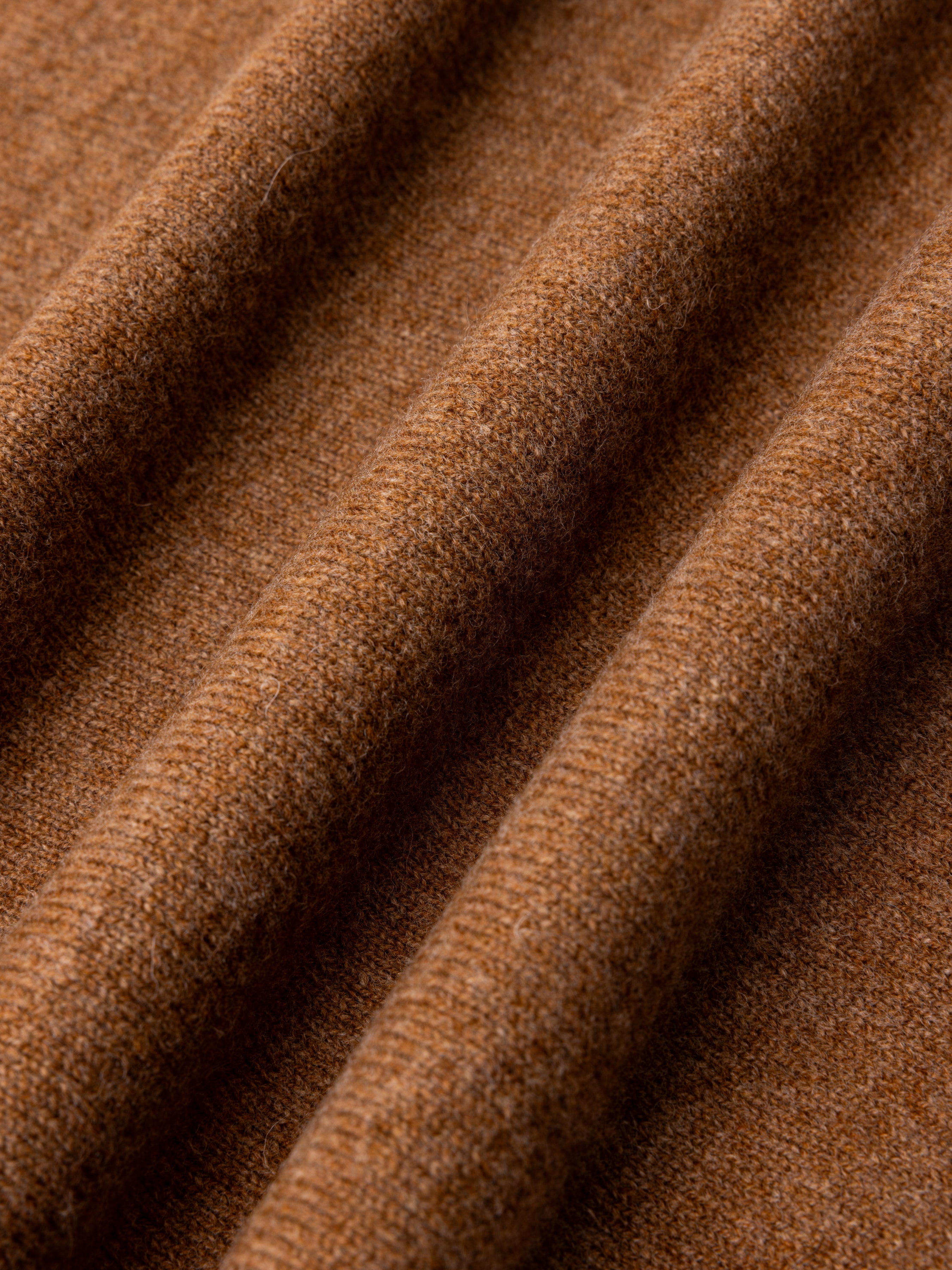 Close-up of brown fine gauge lambswool fabric texture