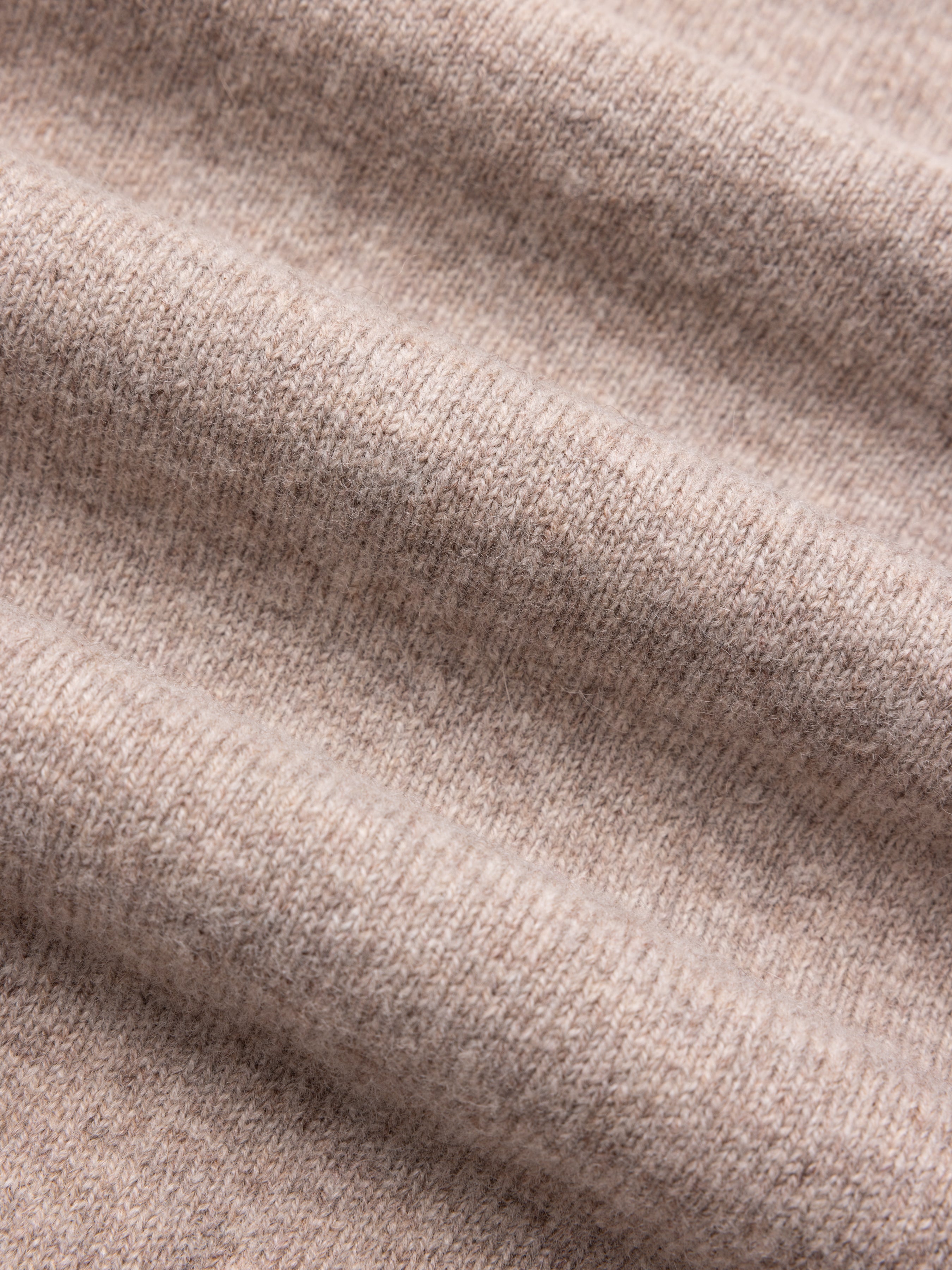 Close-up of beige lambswool fabric texture