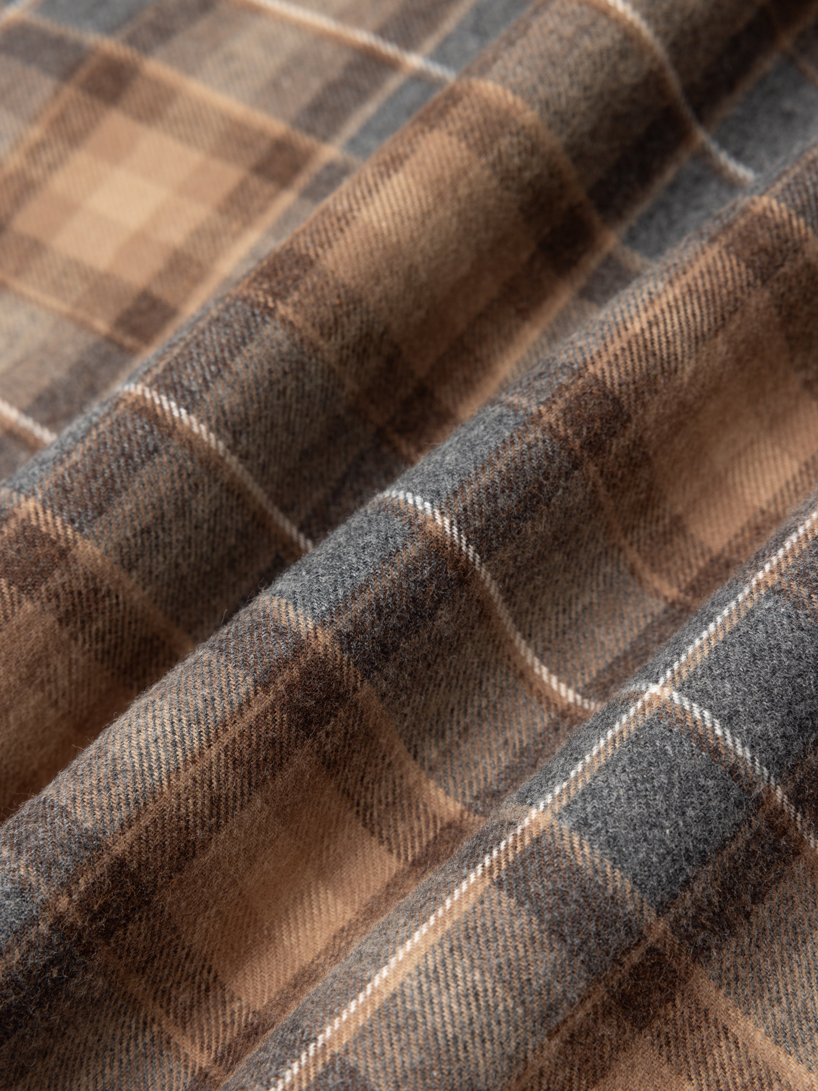 Close-up of plaid fabric with brown and gray colors