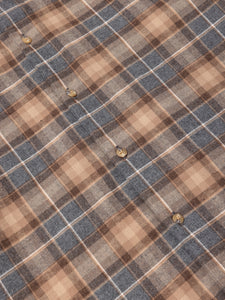 Close-up of a plaid fabric with brown, grey, and beige colors.