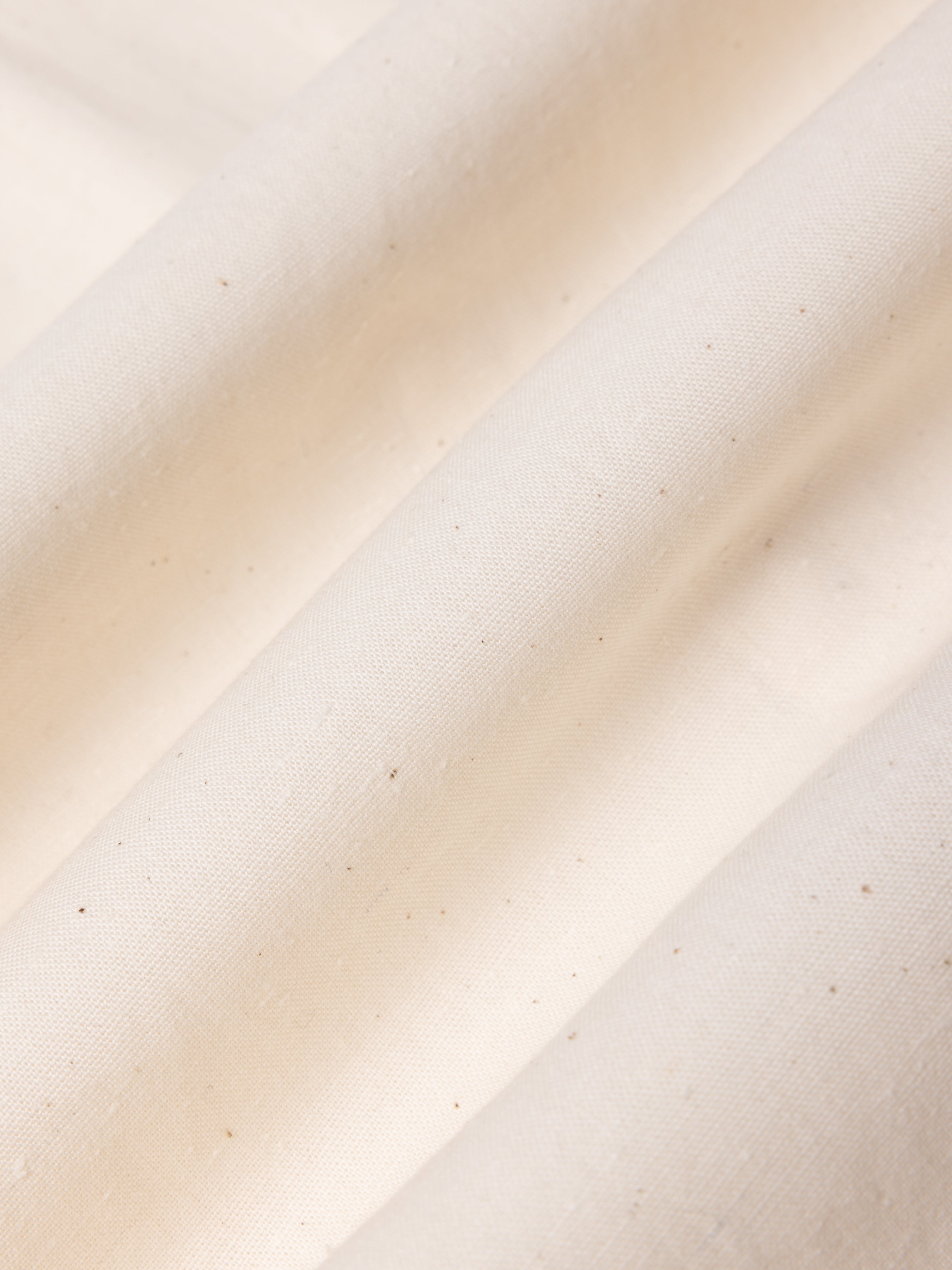Close-up of beige fabric with a subtle texture.