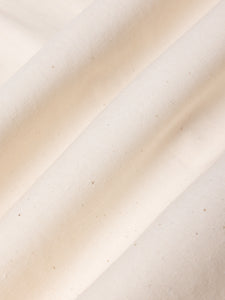 Close-up of beige fabric with a subtle texture.