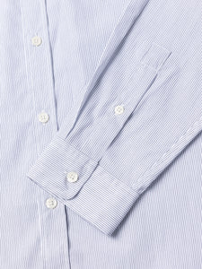 Close-up of the cuff of a blue and white striped shirt