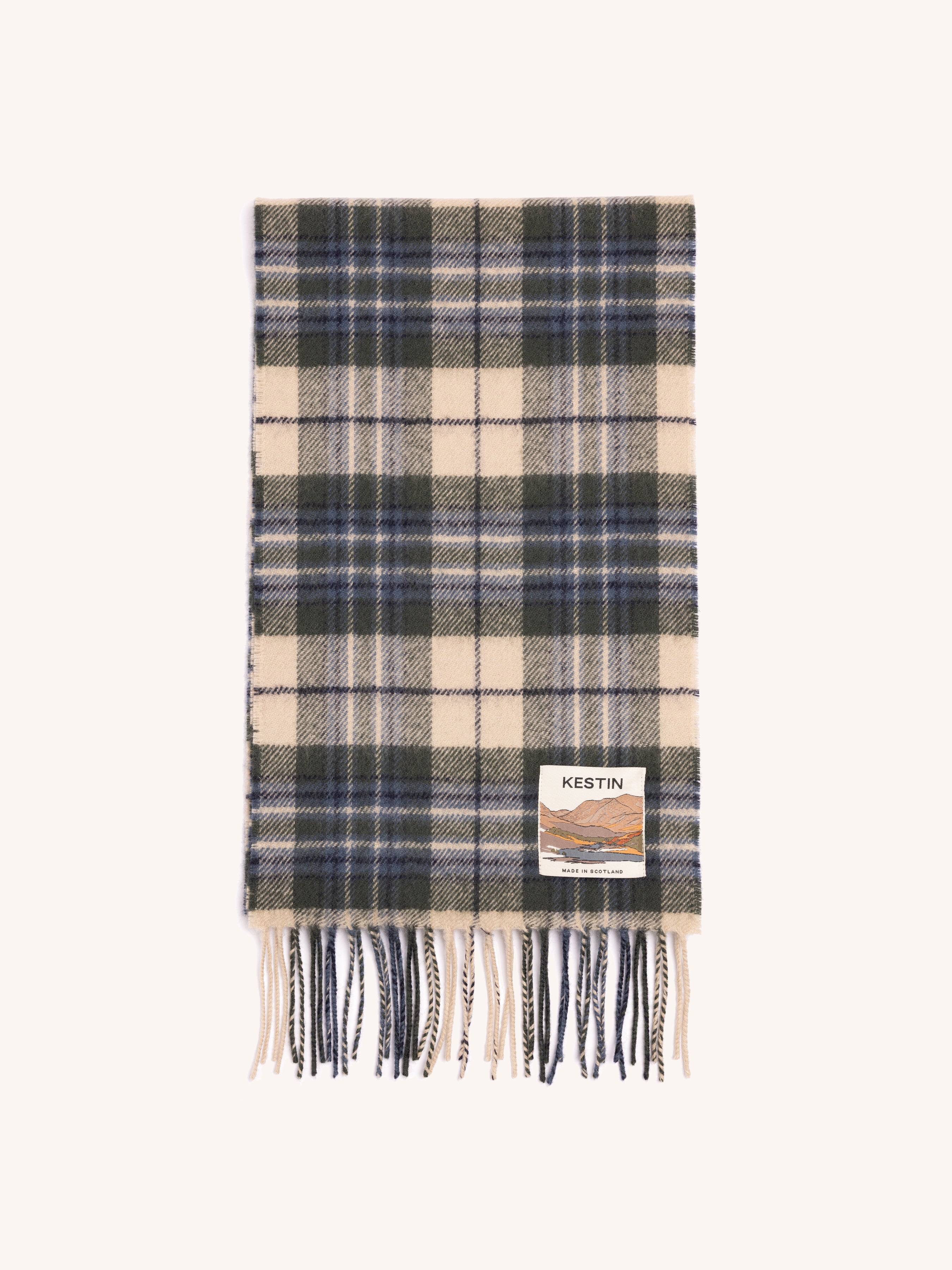 Plaid scarf with fringes and a visible brand label on a white background