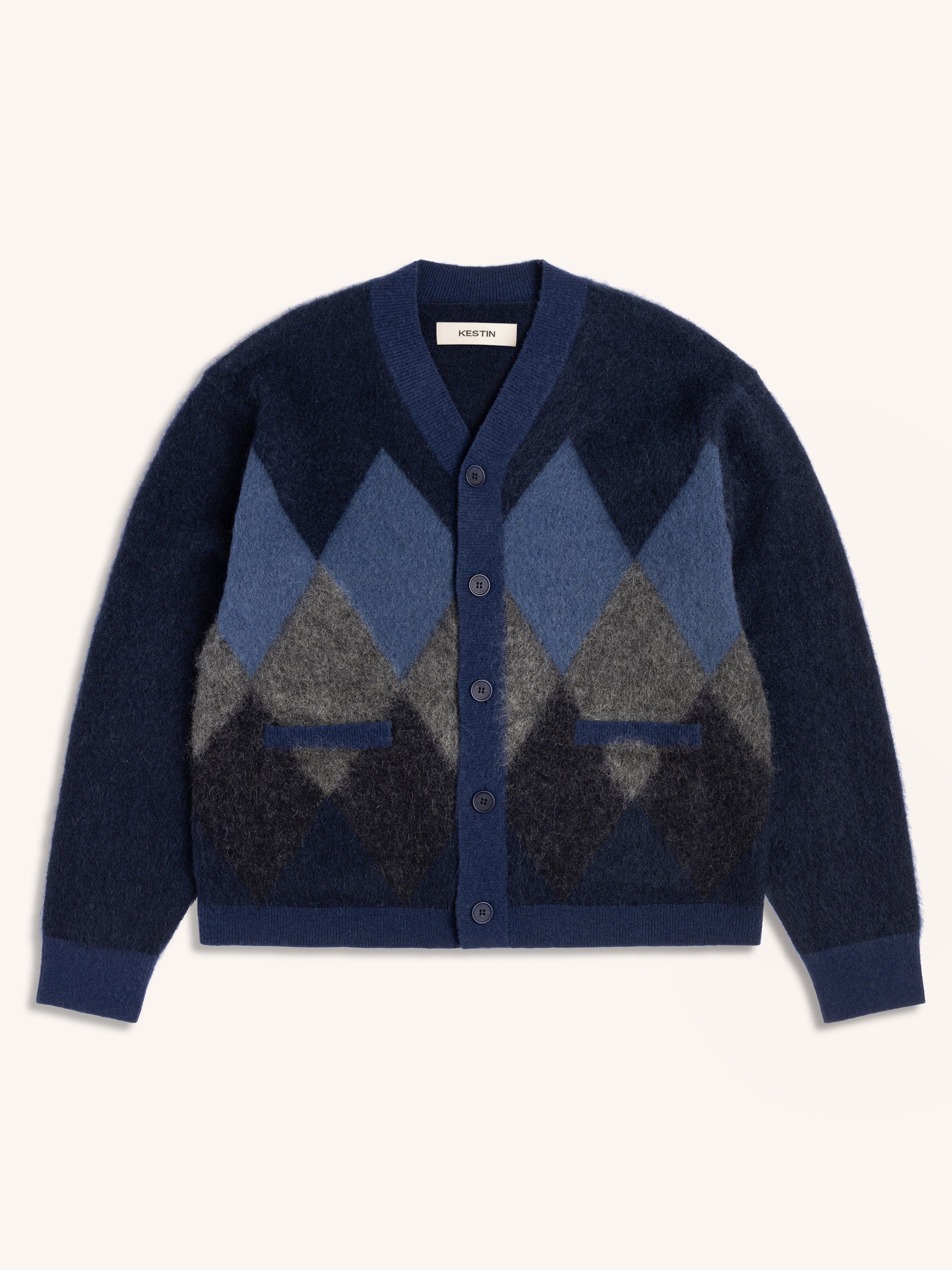 Navy blue cardigan with an argyle diamond pattern on a white background