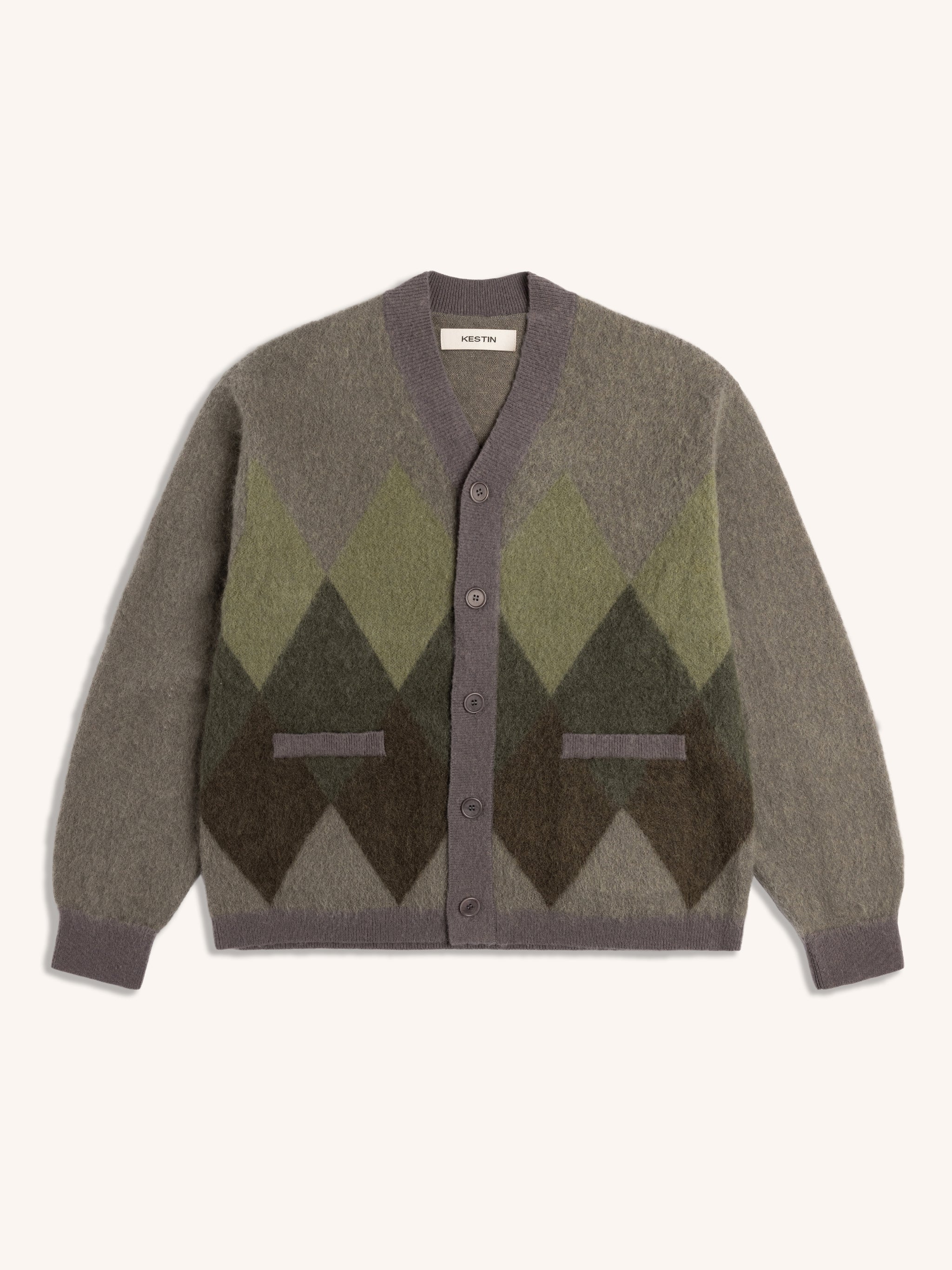 Cardigan with green and brown argyle pattern on a white background