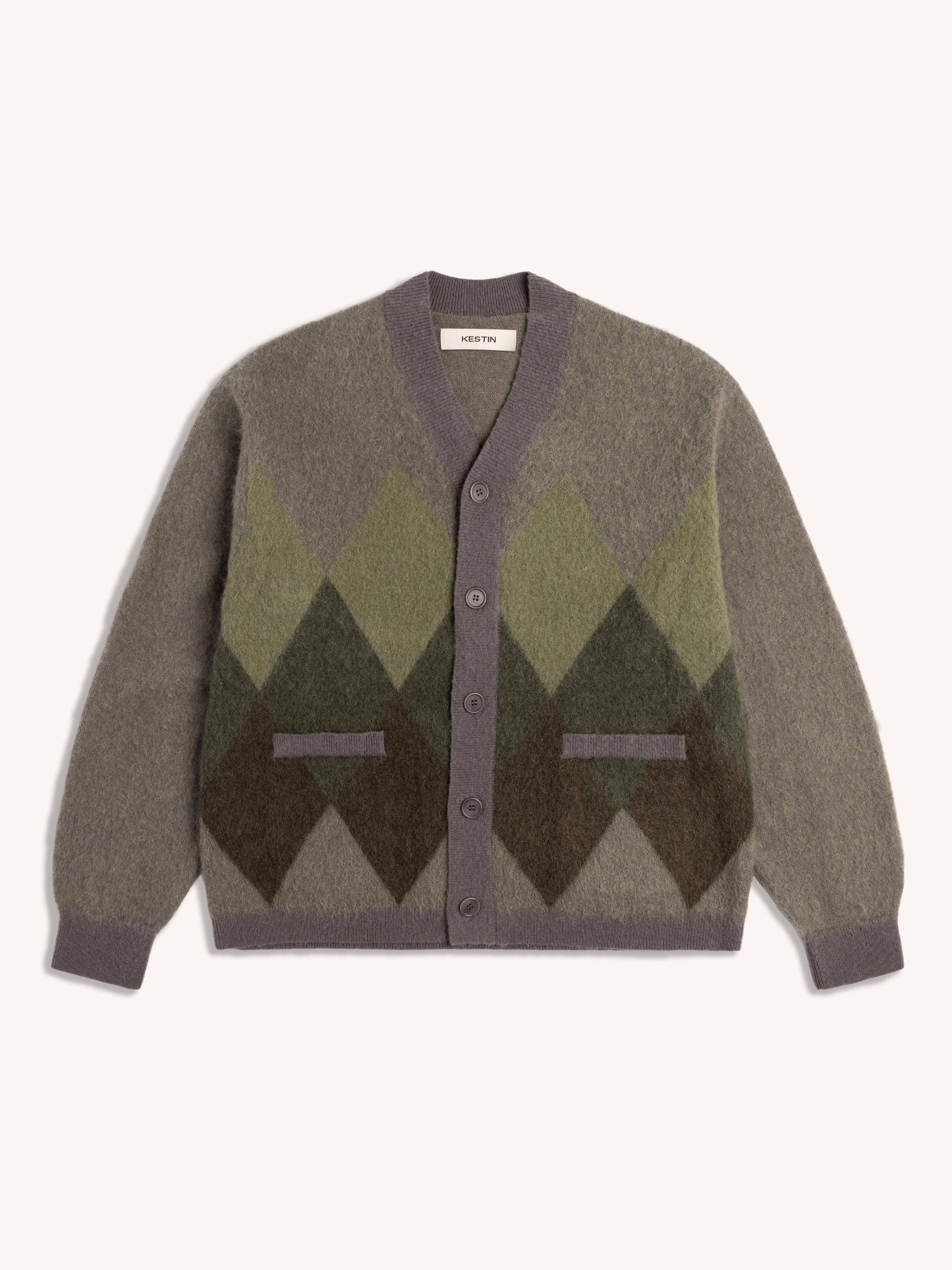 Cardigan with green and brown argyle pattern on a white background