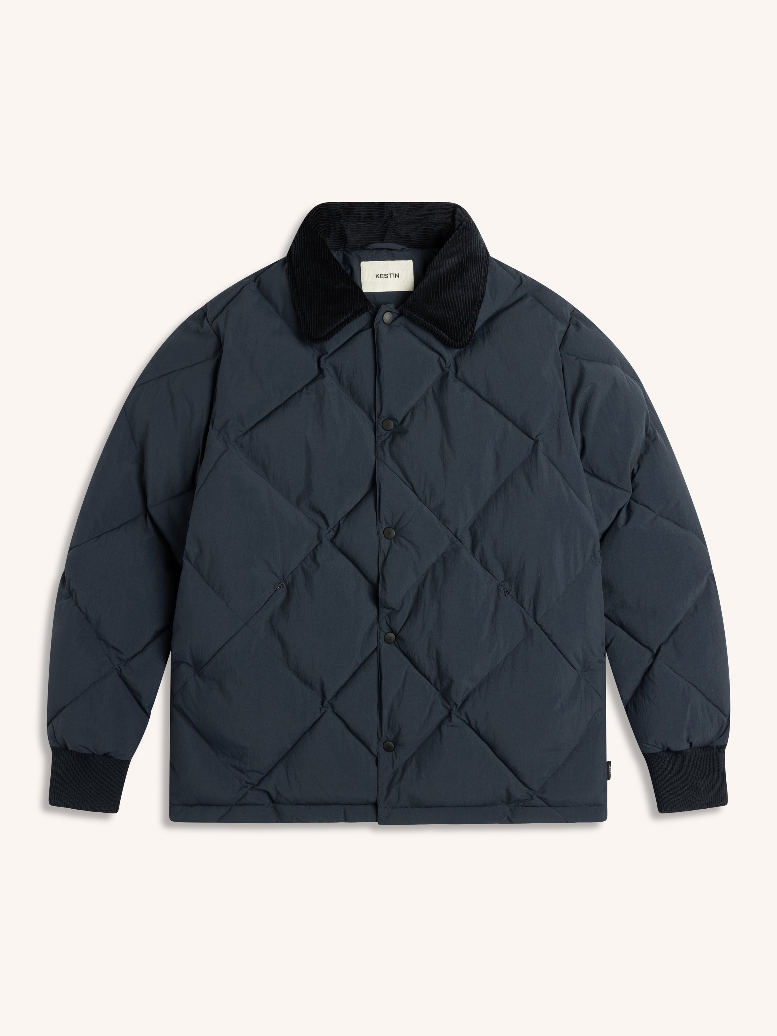 Quilted dark blue jacket on a white background