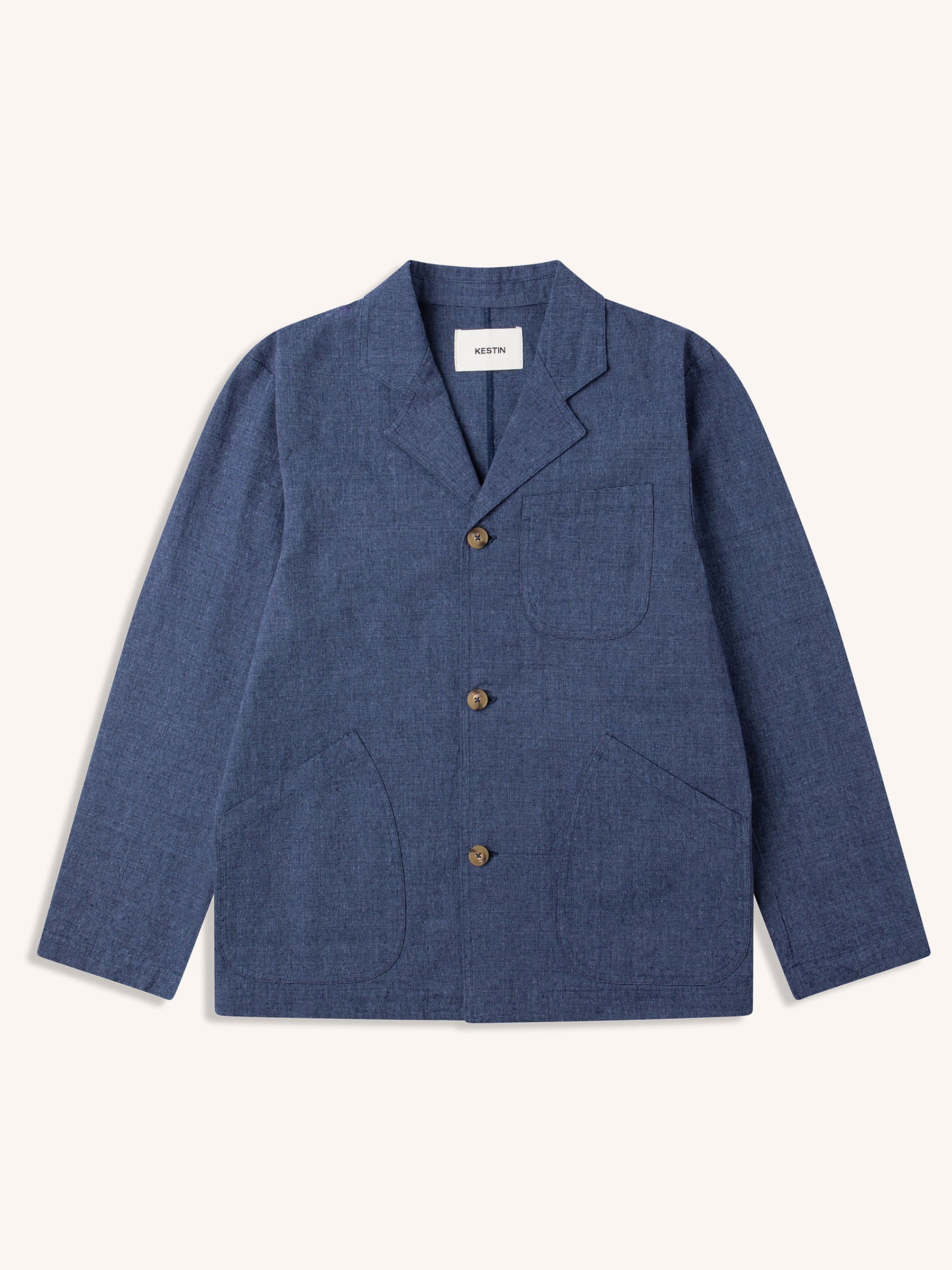 An indigo blue workwear-inspired suit jacket by KESTIN, on a white background.