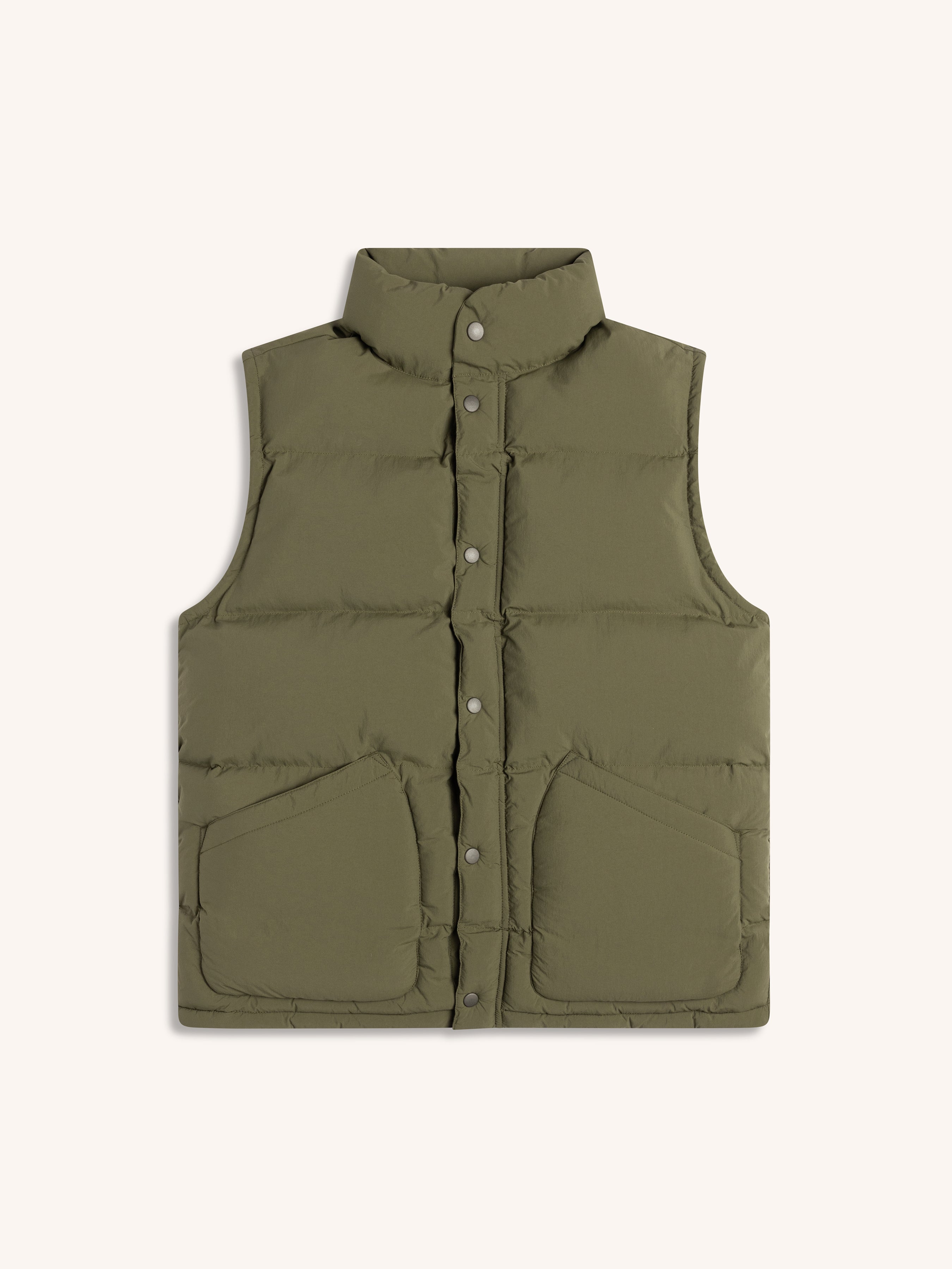 Green puffer vest on a white background