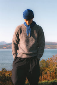 A model wearing made in Scotland knitwear, in the countryside.