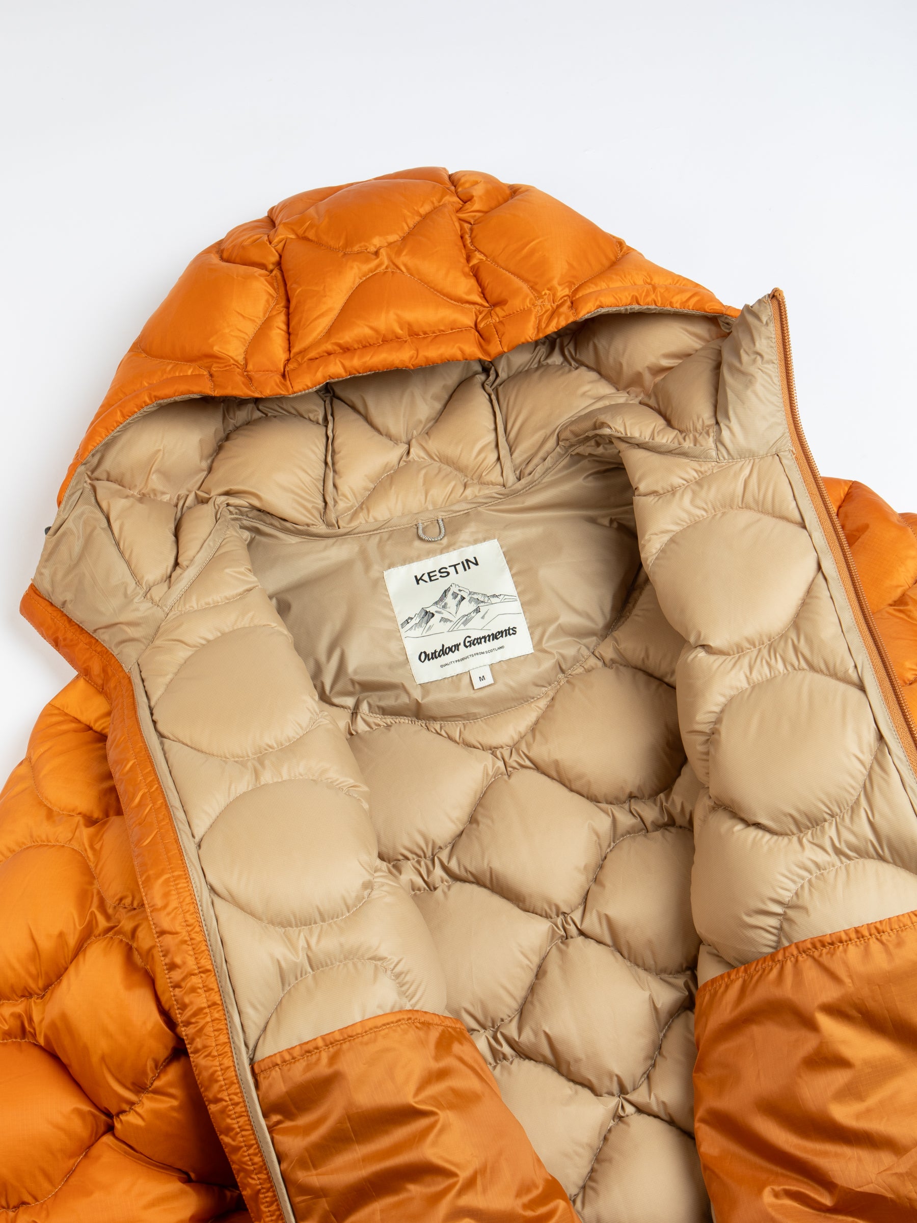 A quilted down jacket from men's clothing brand KESTIN on a white background.