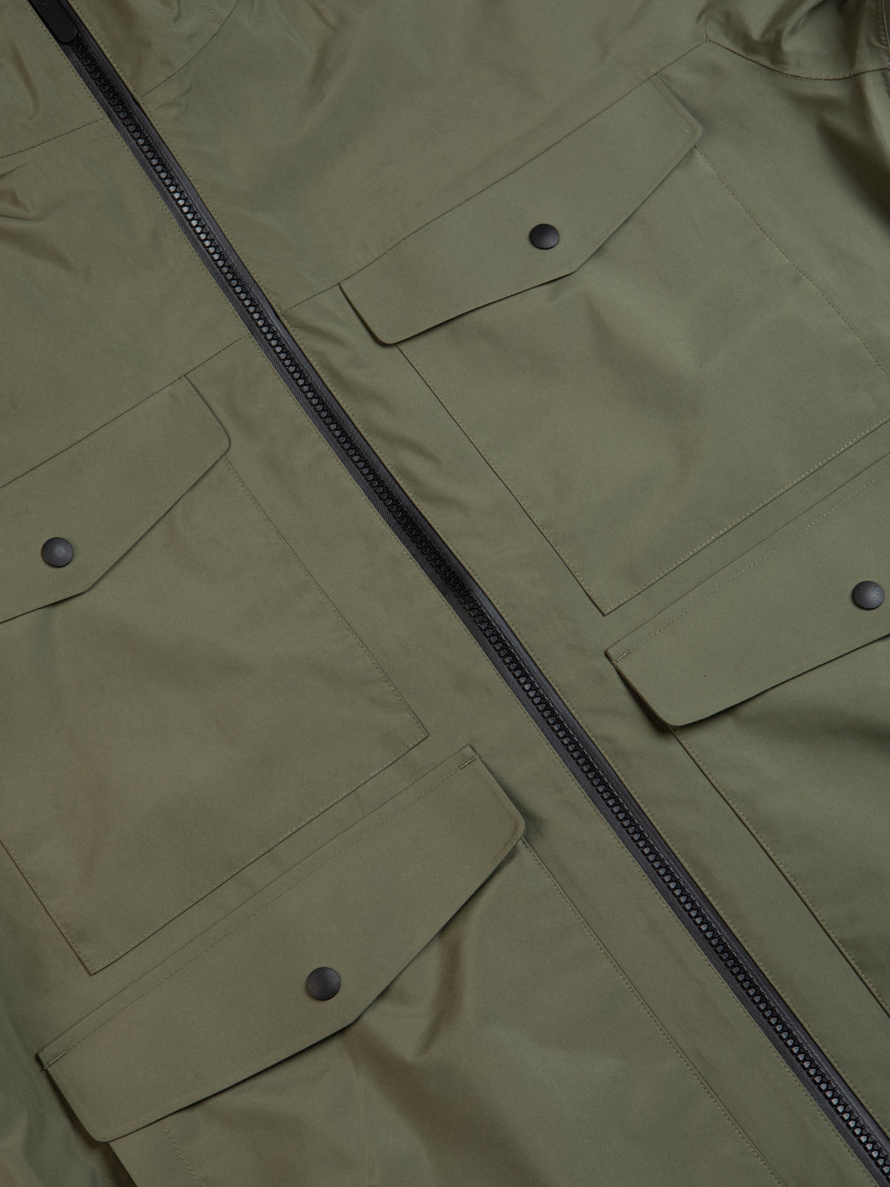 A waterproof jacket with four large patch utility pockets.