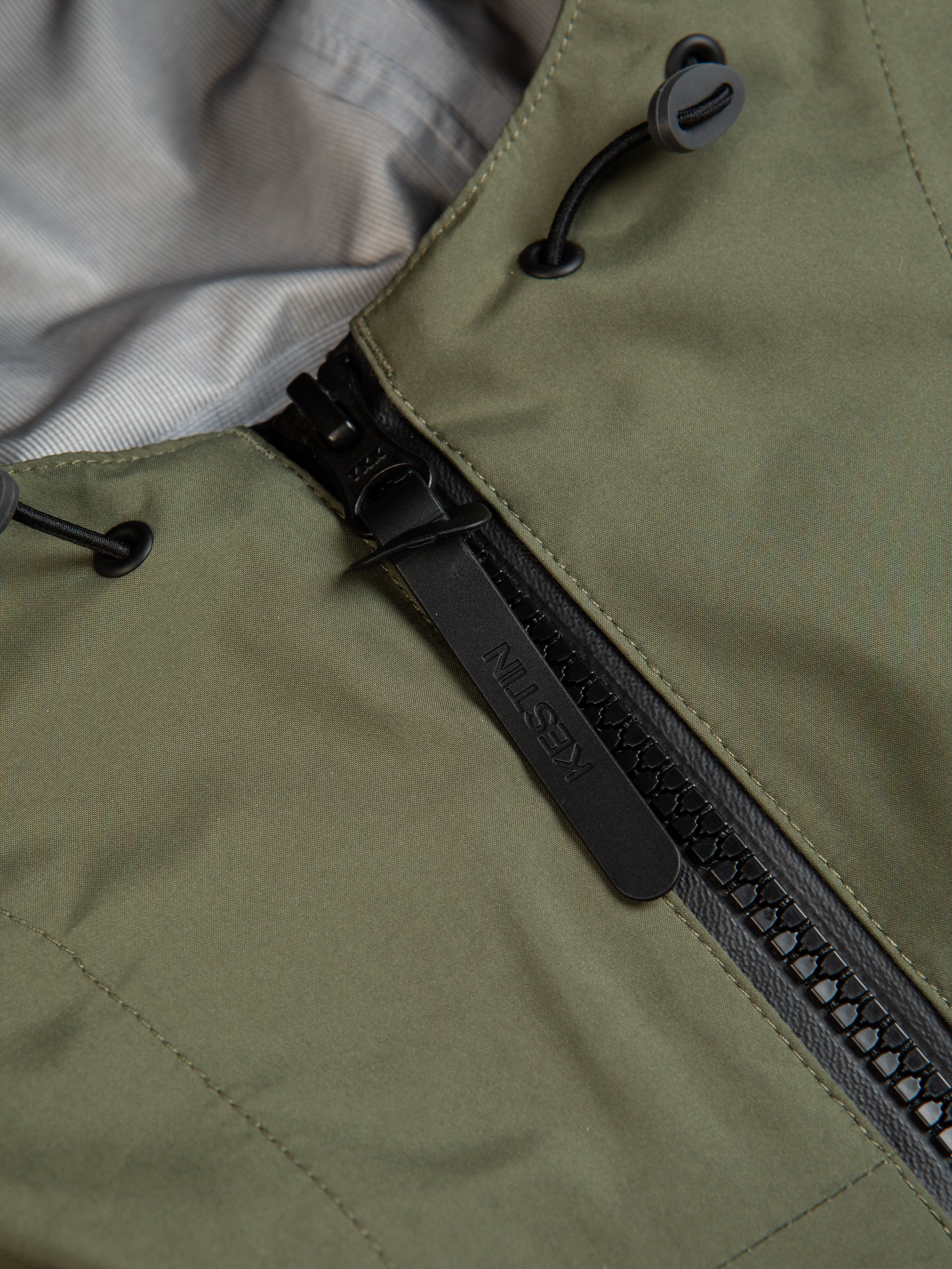 A zipper and pull on a waterproof jacket by menswear brand KESTIN.