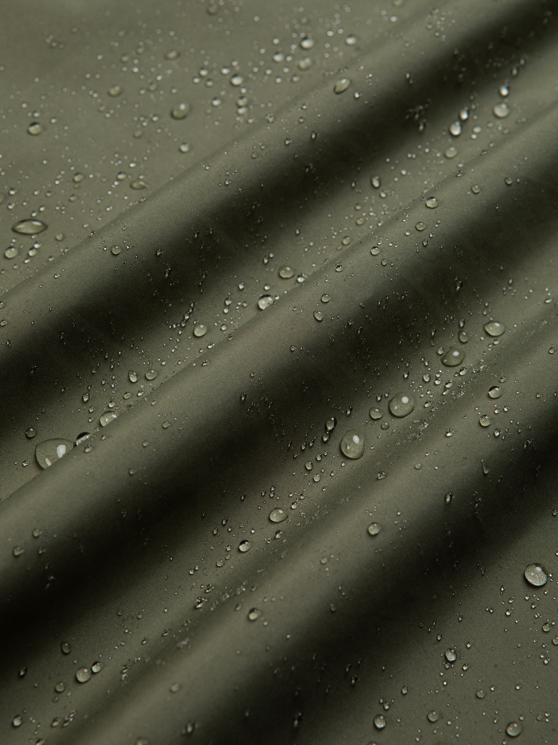 Water beading on a waterproof shell jacket, made by men's clothing brand KESTIN.