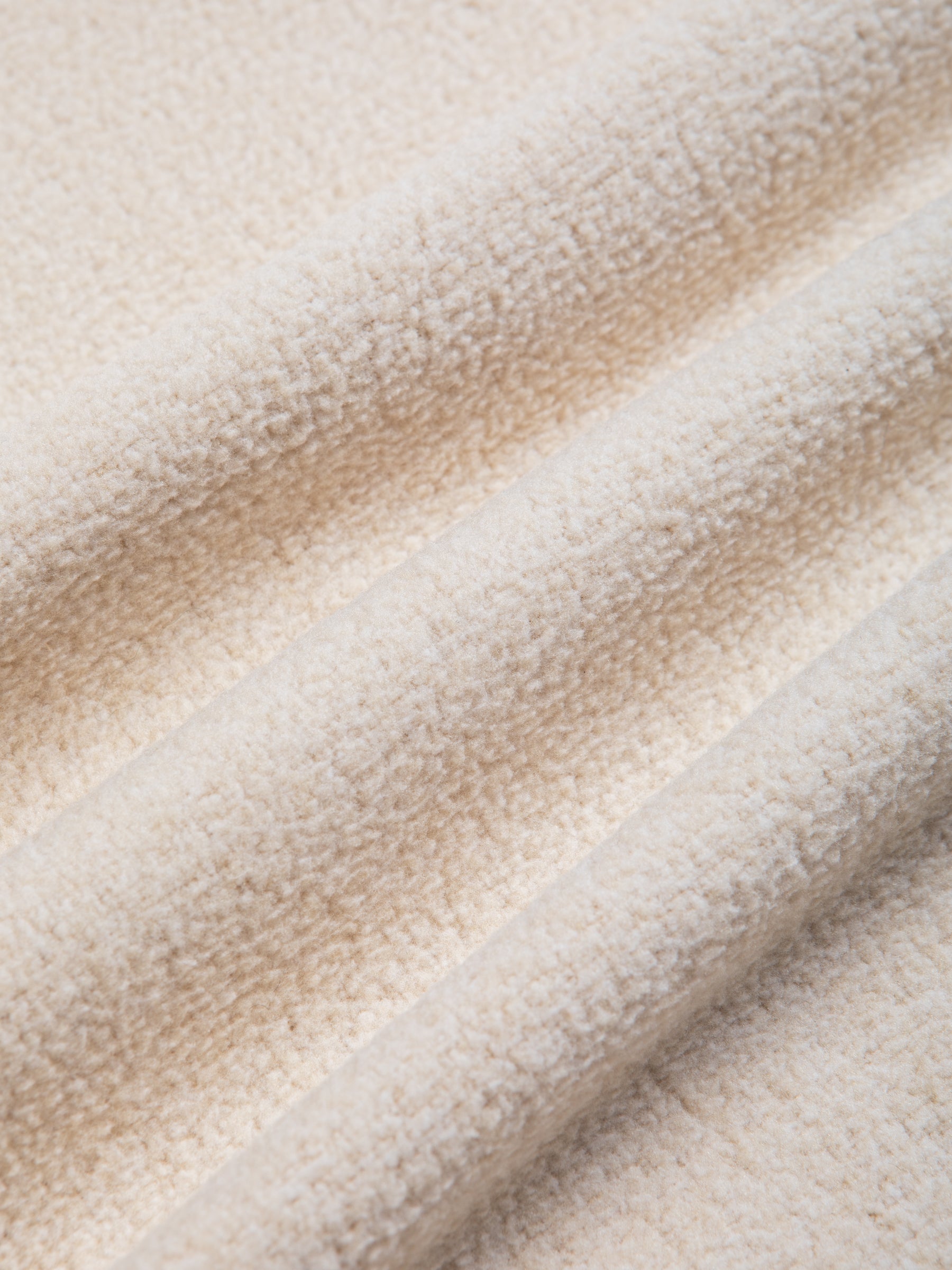 A warm fleece fabric in a cream white colour, used by men's brand KESTIN to make a fleece vest.