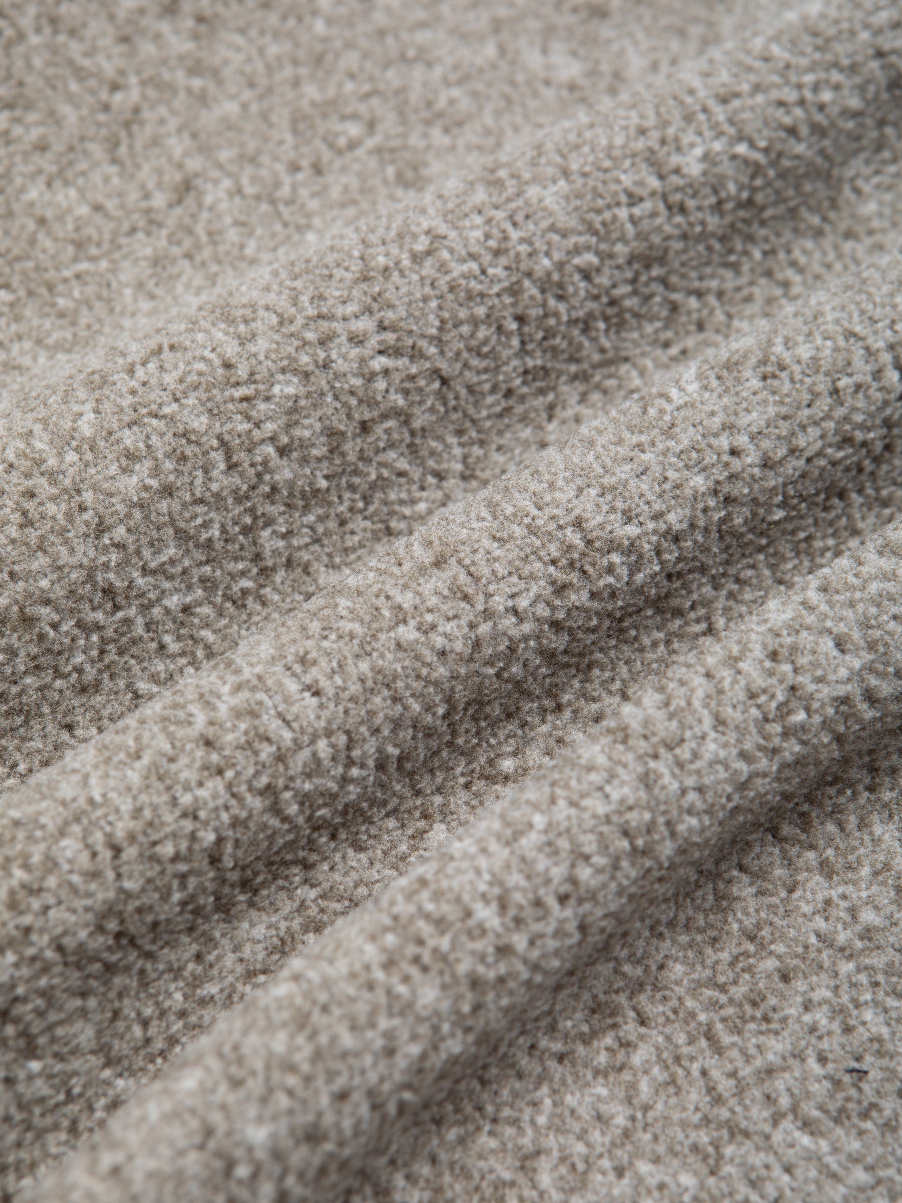 A green fleece material, made using recycled polyester.