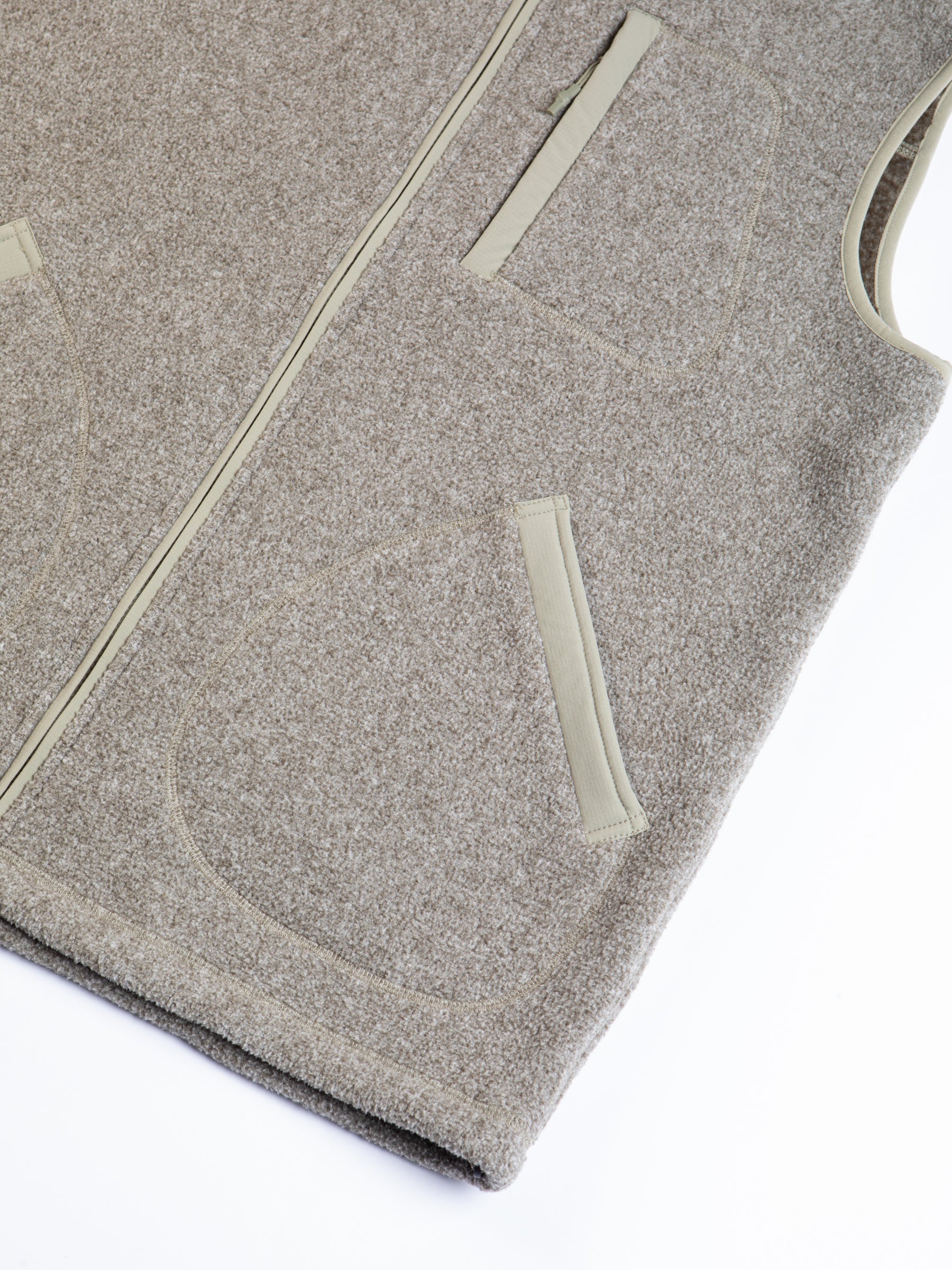 A green marled fleece material used to make a men's fleece vest, on a white background.