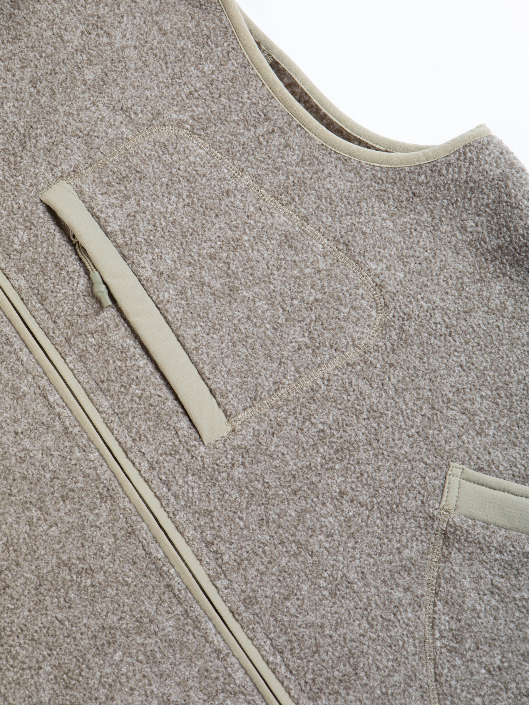 A green marled fleece material on a men's outerwear vest.