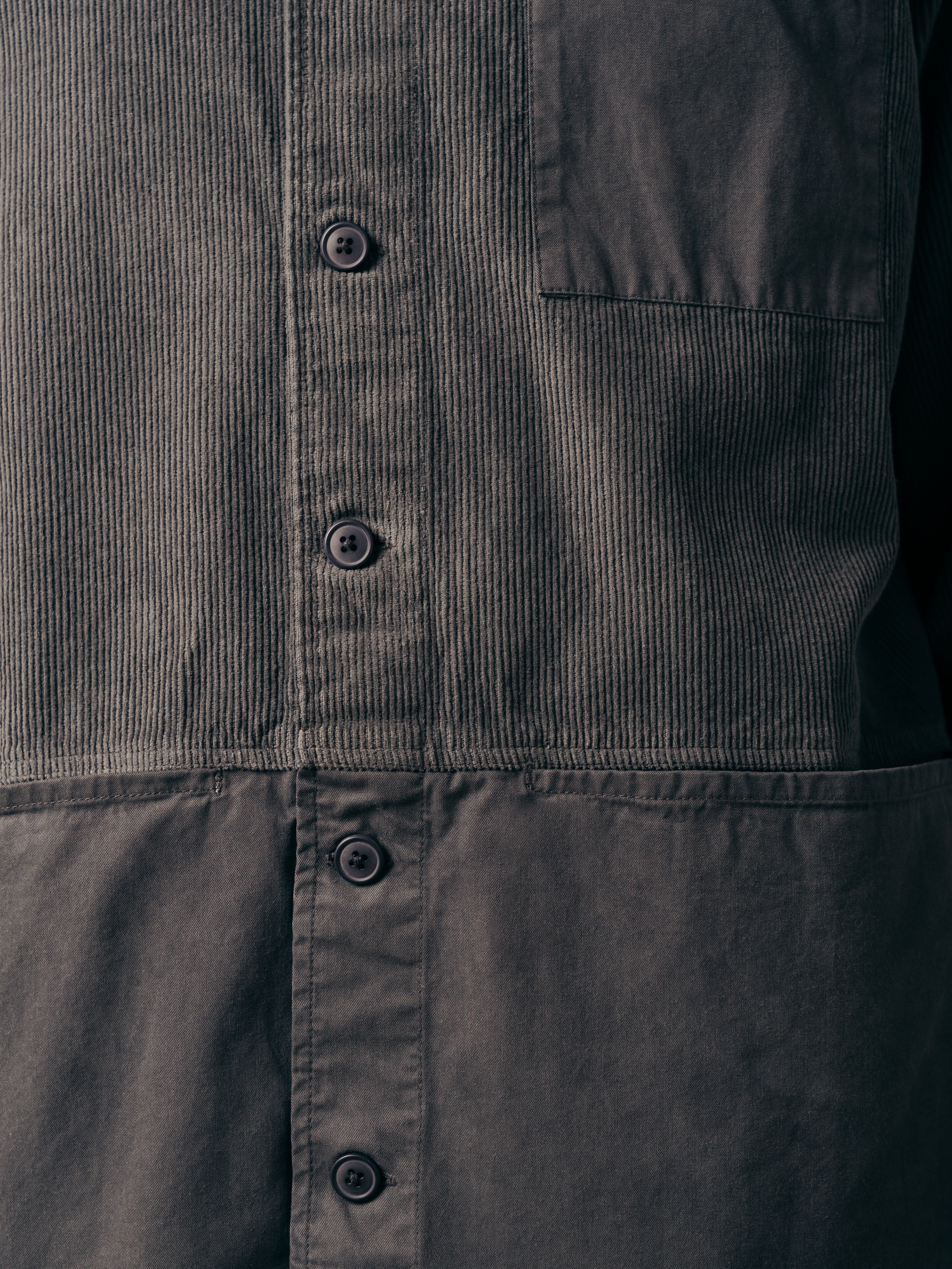 A close-up of the pockets of the Rosyth Overshirt in a twill and corduroy blend.