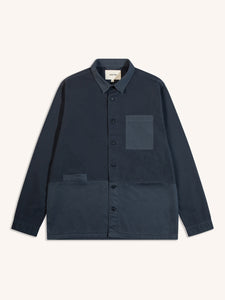 A blue overshirt from menswear designer KESTIN on a white background.