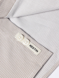 A close-up of the logo patch, sewn to the placket of the KESTIN Raeburn Button Down Shirt.