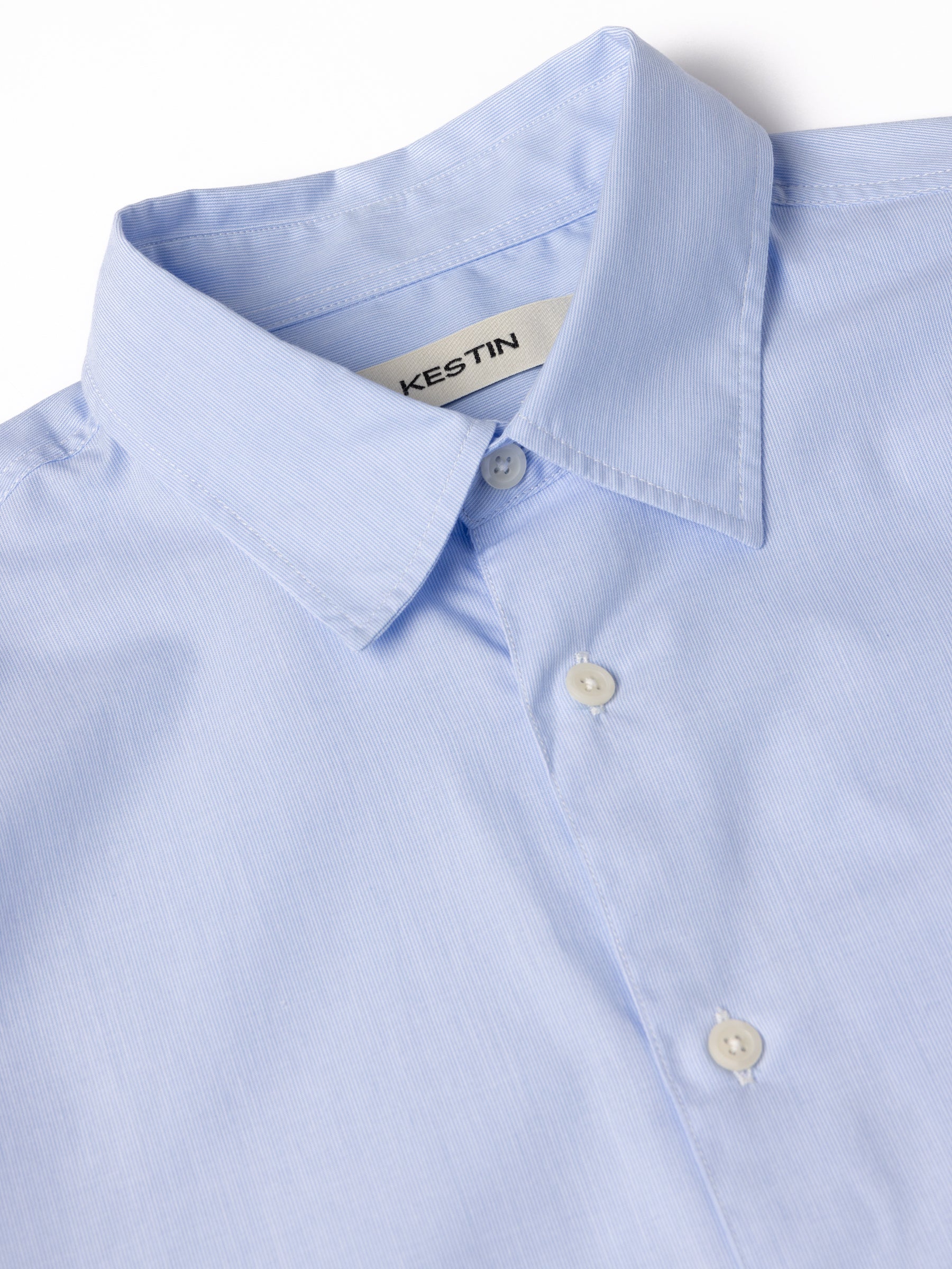 A close-up of the collar of the KESTIN Dirleton Shirt in a lightweight sky blue colourway.