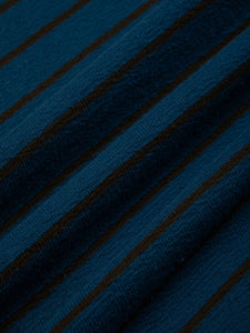 A textured cotton fabric with a stripe pattern, used to make a t-shirt.