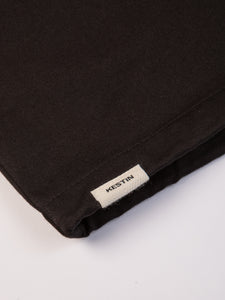 A woven logo tag to the hem of the Aberfeldy Windbreaker by KESTIN.