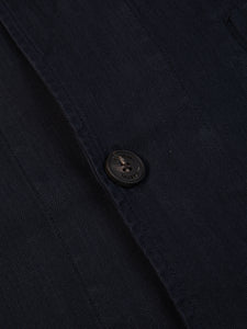 A close-up of a button on the KESTIN Huntly Jacket in Midnight Herringbone.