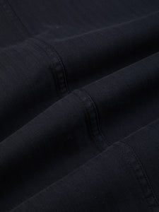 A close up of a dark blue cotton herringbone fabric.