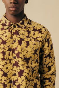A model wearing a floral Japanese jacquard overshirt in yellow and red.