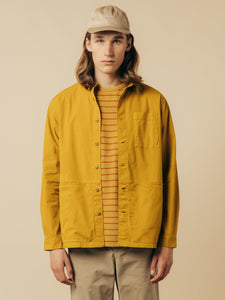 A model wearing a chore-coat and striped tee from menswear brand KESTIN.