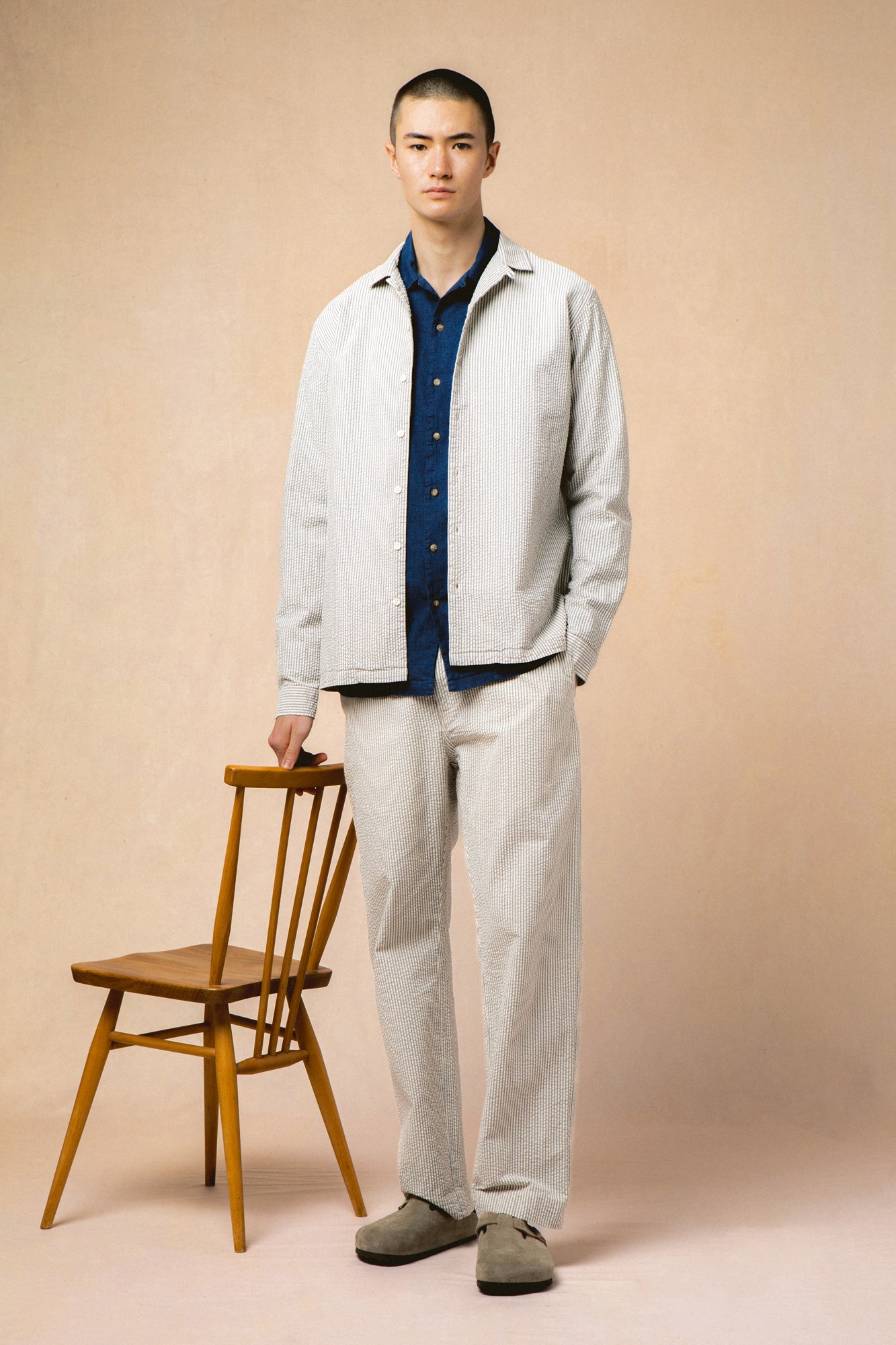 A model wearing matching stripe seersucker trousers and shirt.