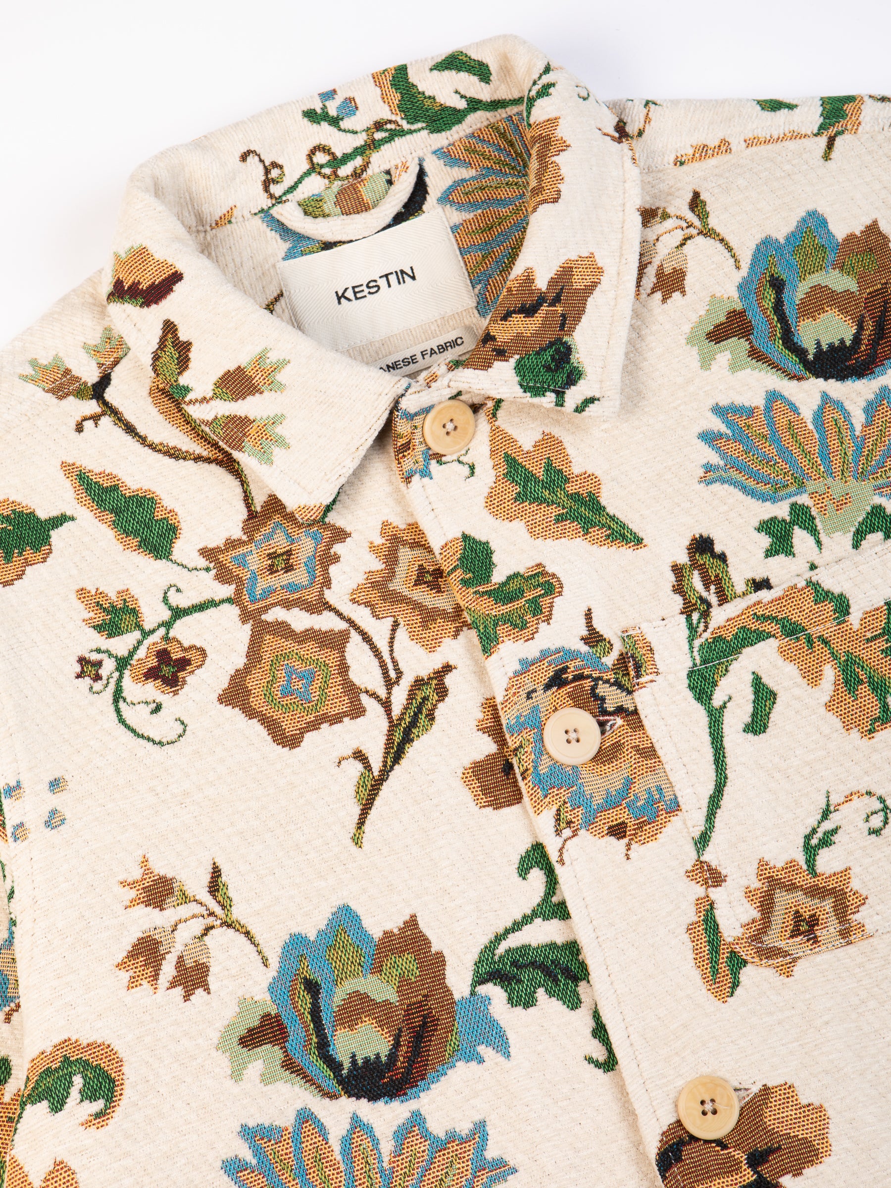 The buttoned front and collar of the KESTIN Ormiston Jacket in sand jacquard.