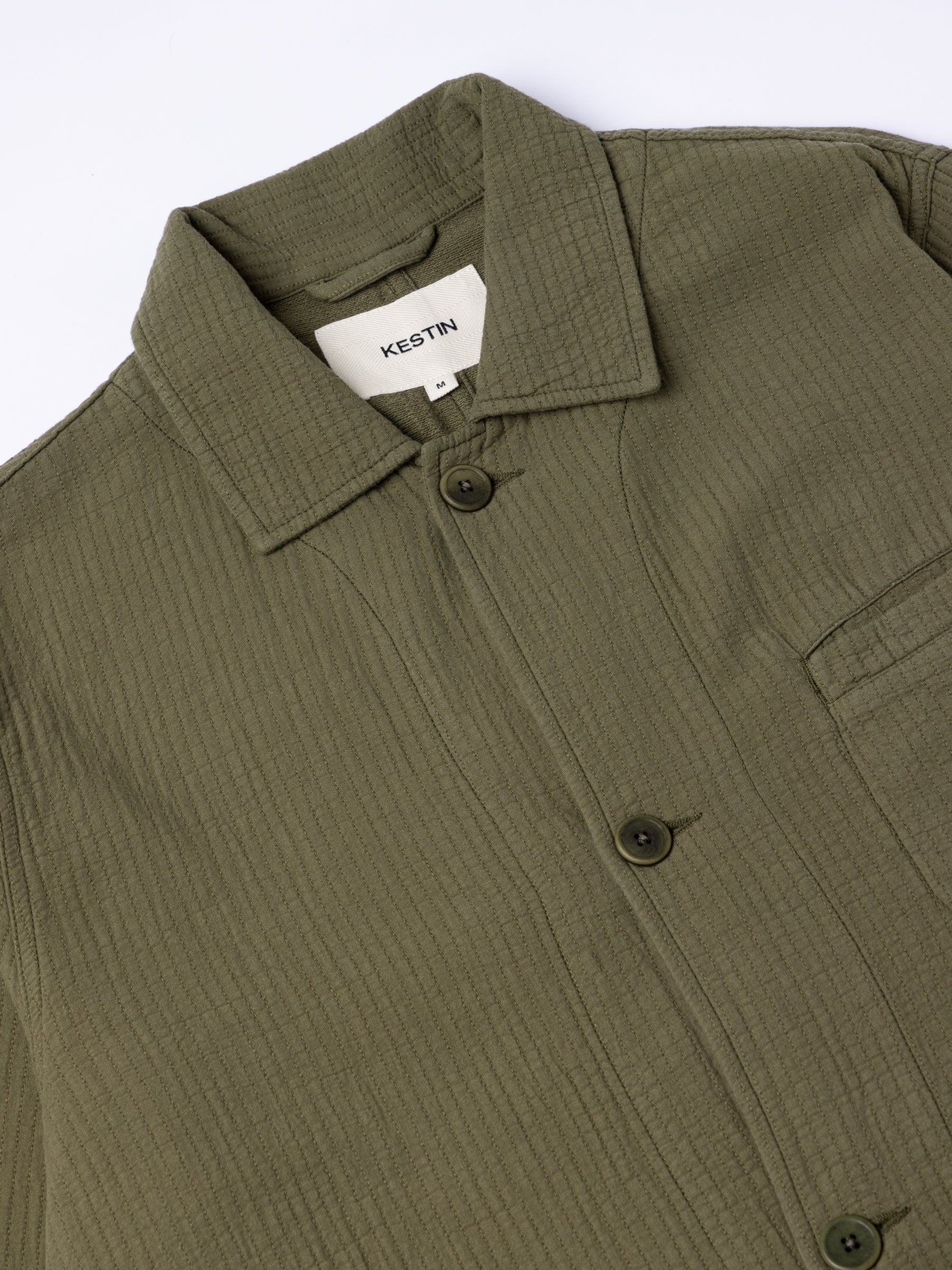 The front of the Huntly Jacket from menswear brand KESTIN, in olive green.