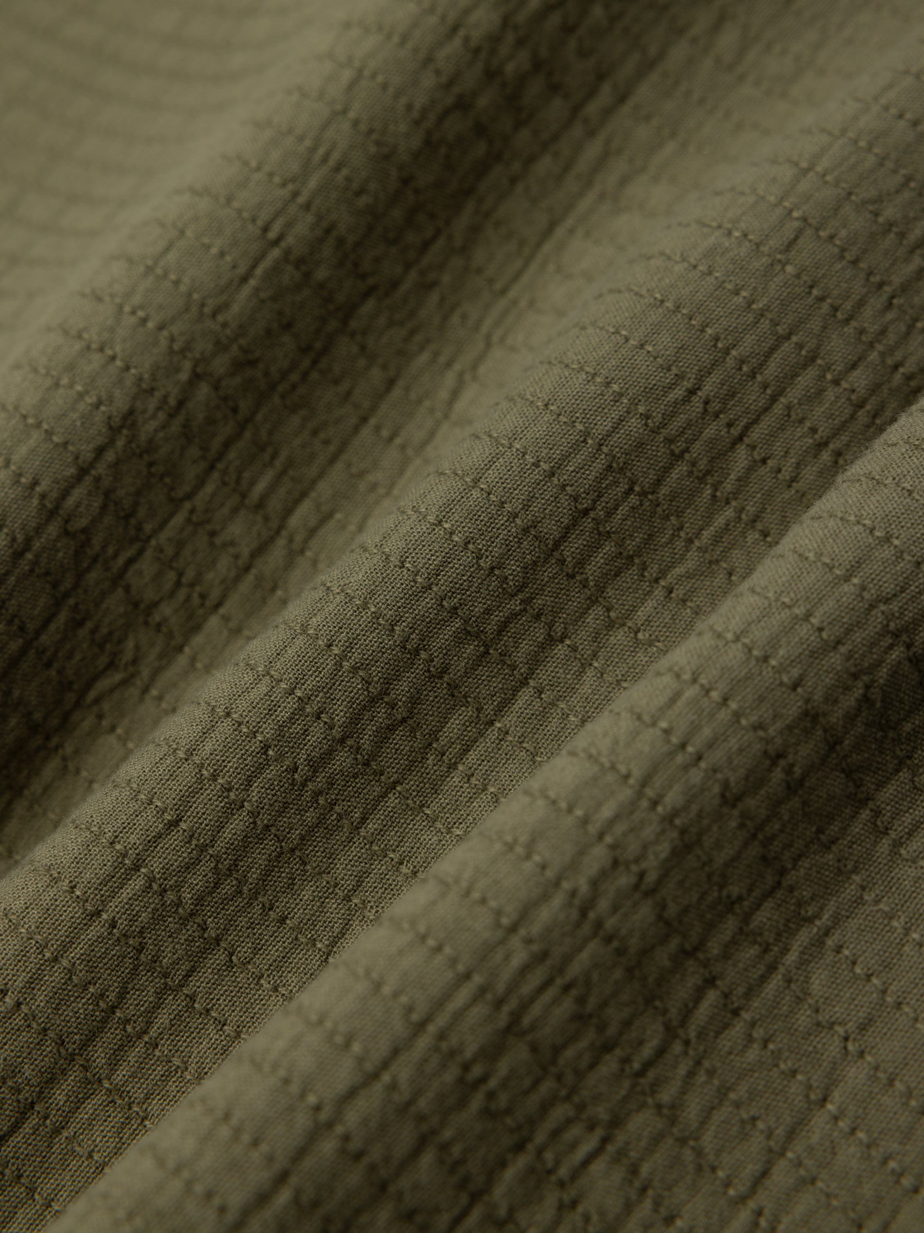 An olive green fabric made in Portugal from 100% Cotton.