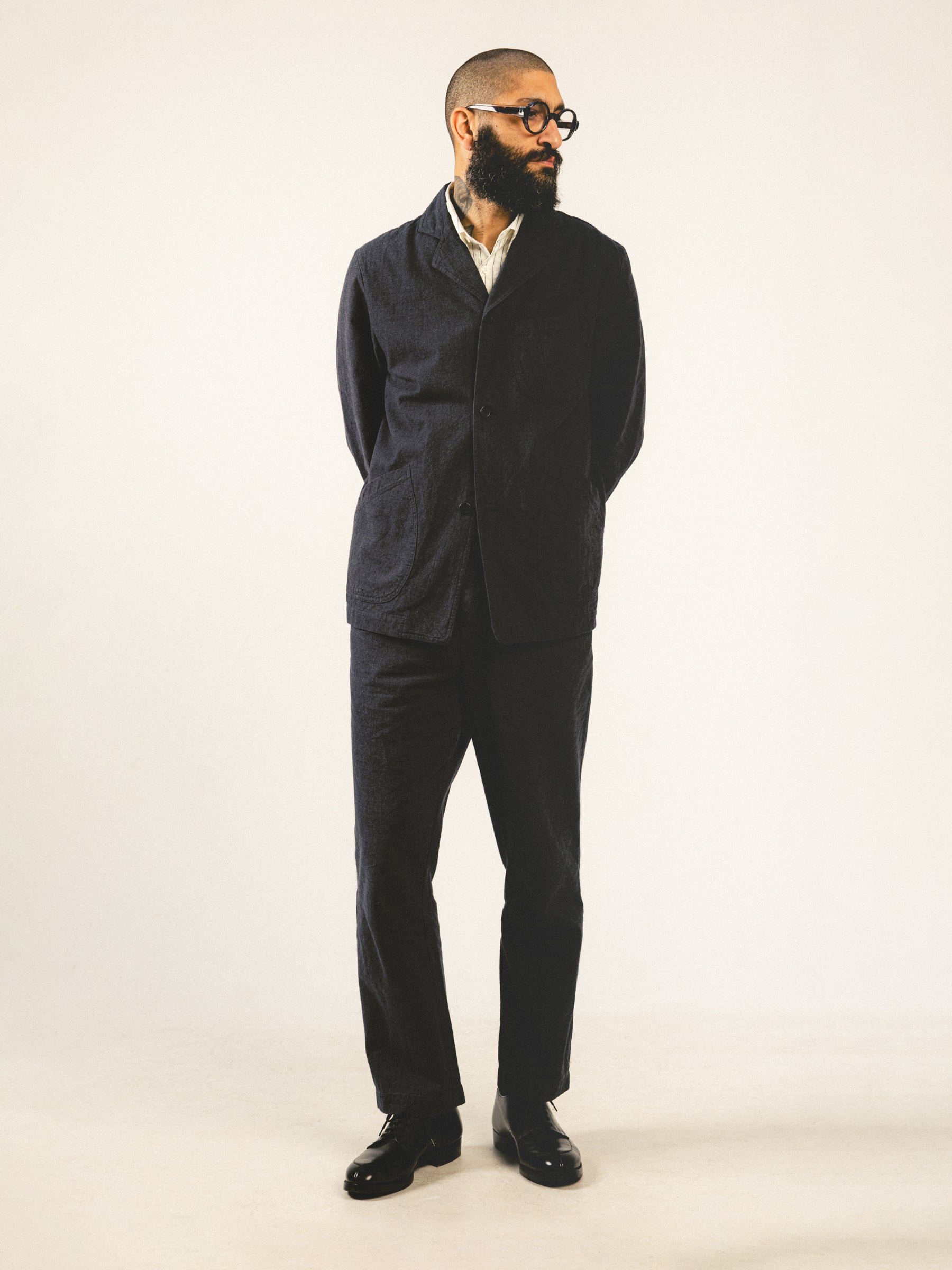 A man wearing a charcoal grey suit made from a blend of cotton and linen.