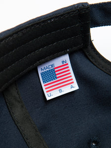 A Made in the USA logo tag to the inside of a six panel cap by KESTIN.