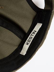 A woven logo tag to the inside of a six panel cap by KESTIN.