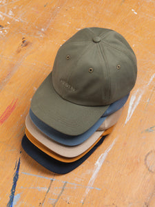 A stack of six panel caps, designed in Scotland and made in the USA by KESTIN.