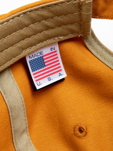 A Made in the USA tag, sewn to the inside of a cotton twill six panel cap.