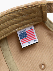 A Made in the USA tag to the inside of a six panel cap by KESTIN.