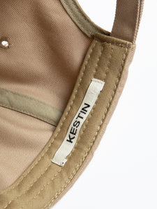A woven logo tag to the inside of a six panel cap by Scottish menswear brand KESTIN.