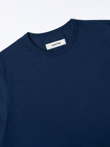 A close-up of the ribbed crew neck of the Drem T-Shirt from KESTIN.