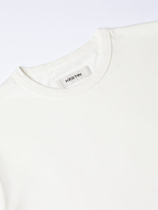 A close-up of the ribbed crew neck and neck label from the KESTIN Drem Tee.