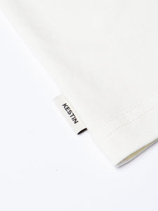A woven flag label featuring a KESTIN logo, sewn to the Drem Tee.
